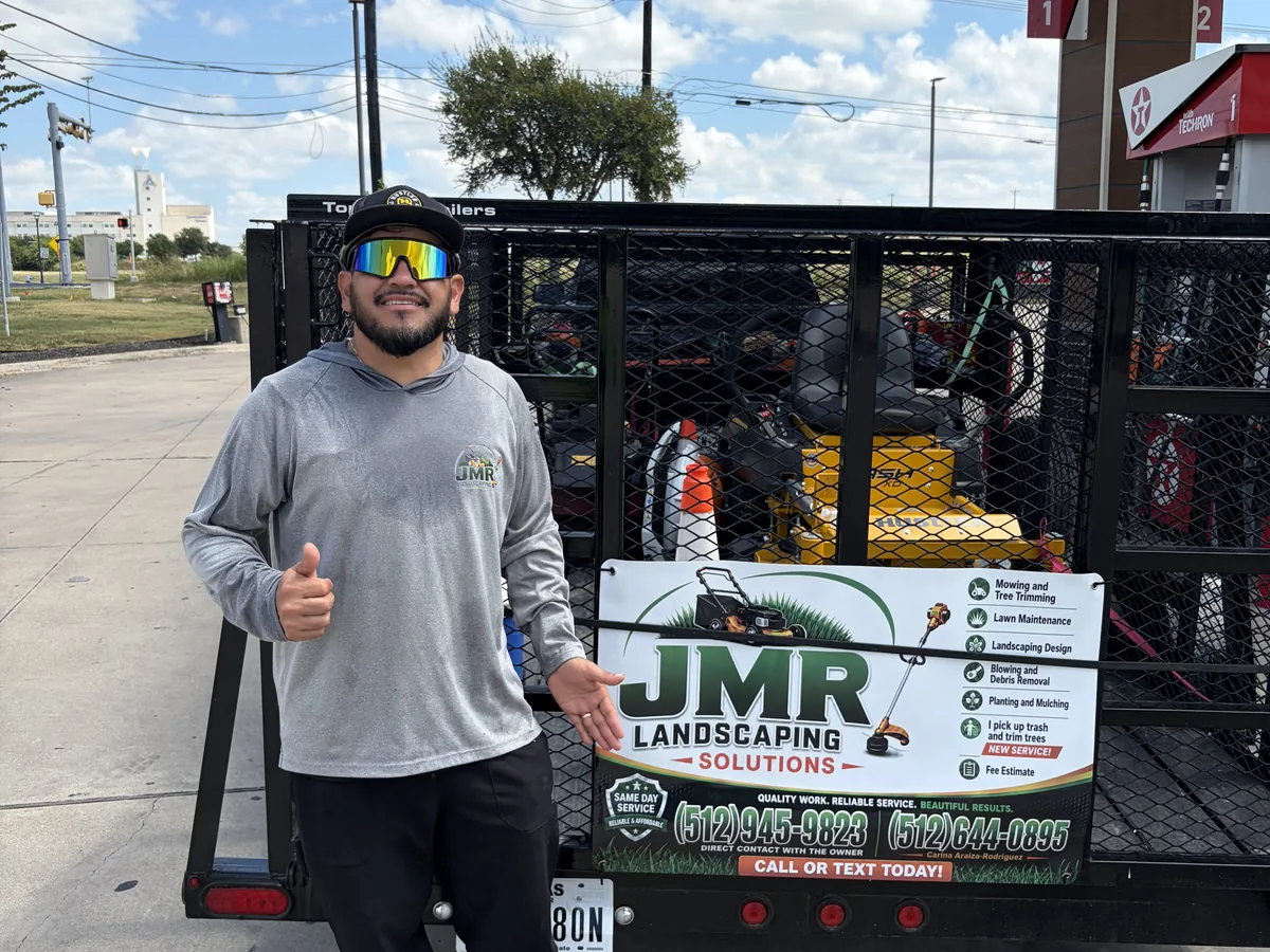 Landscaping trailer loaded with mowers and hand equipment