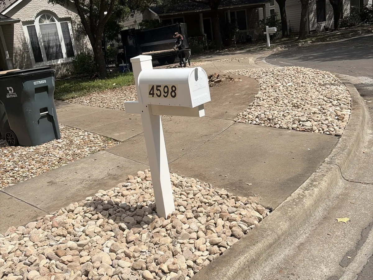 White river rock bed installed around a curbside mailbox